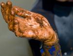 Matthew Ferraro holds a crude oil covered crab