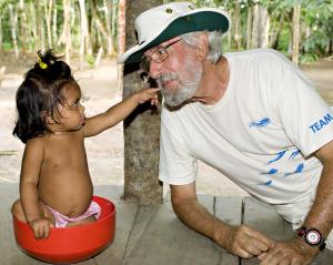 Jean-Michel Cousteau with child in the Amazon